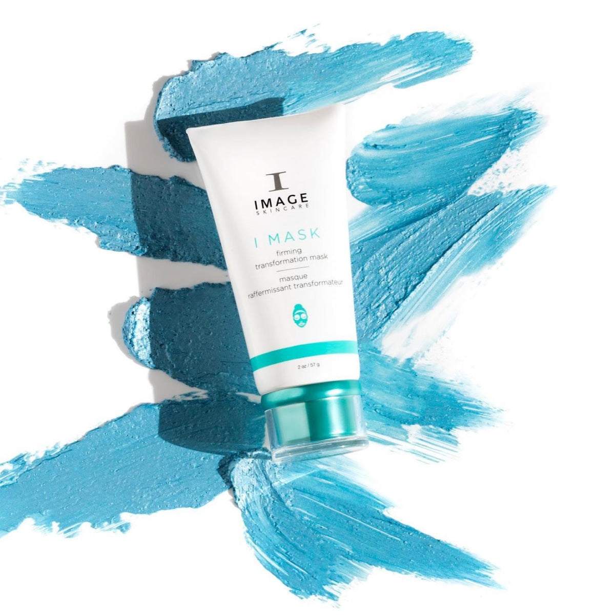 Tube blanc I MASK masque raffermissant transformateur d’Image Skincare, bouchon turquoise, sur des traînées de masque bleu