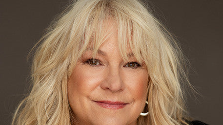 Portrait of singer Lulu Hughes, smiling, with long blond hair