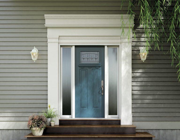 Blue front door between two frosted glass sidelights on a grey-sided house, with plants on the porch